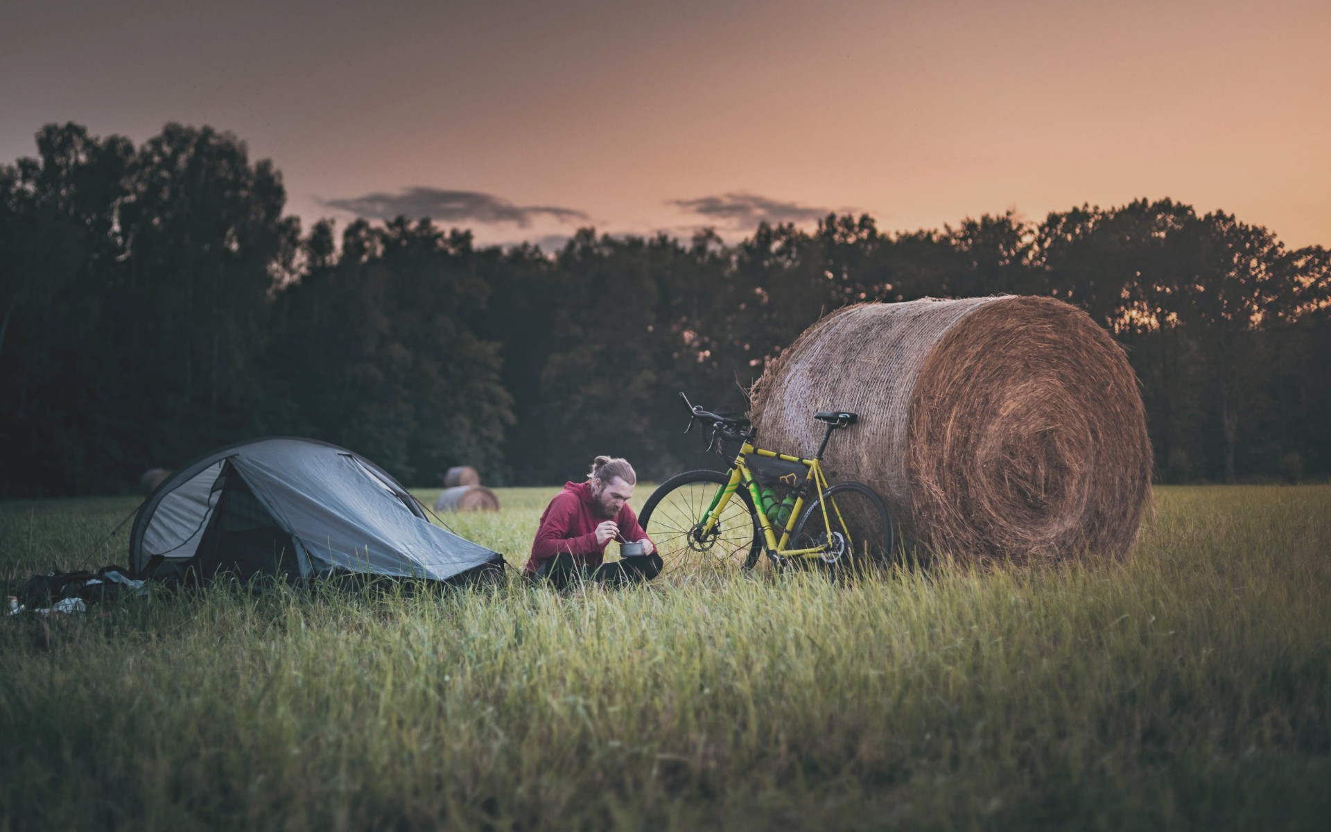 Bikepacker at camp during golden hour